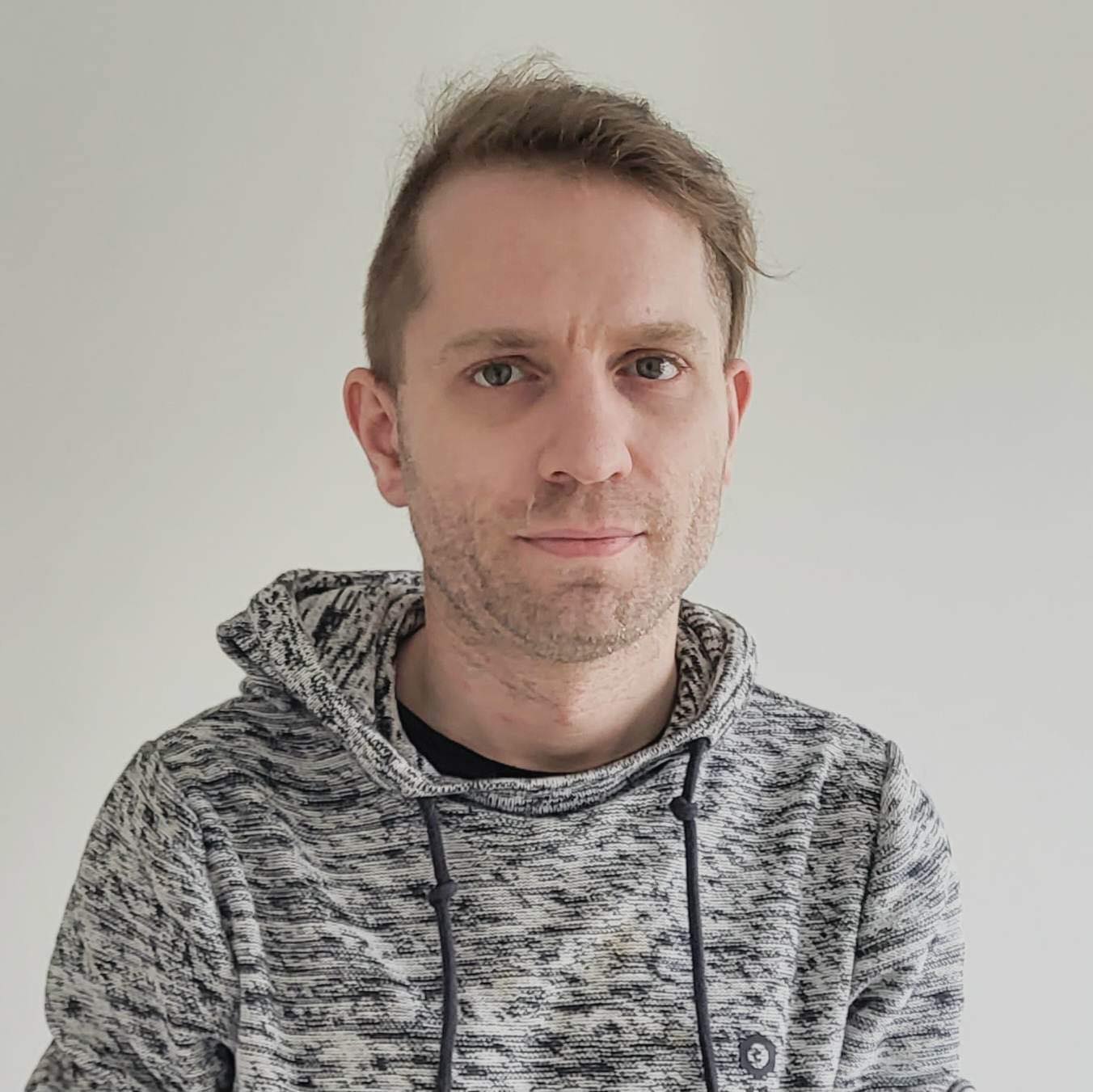 Monochrome portrait of a composed professional in a minimal architectural setting.